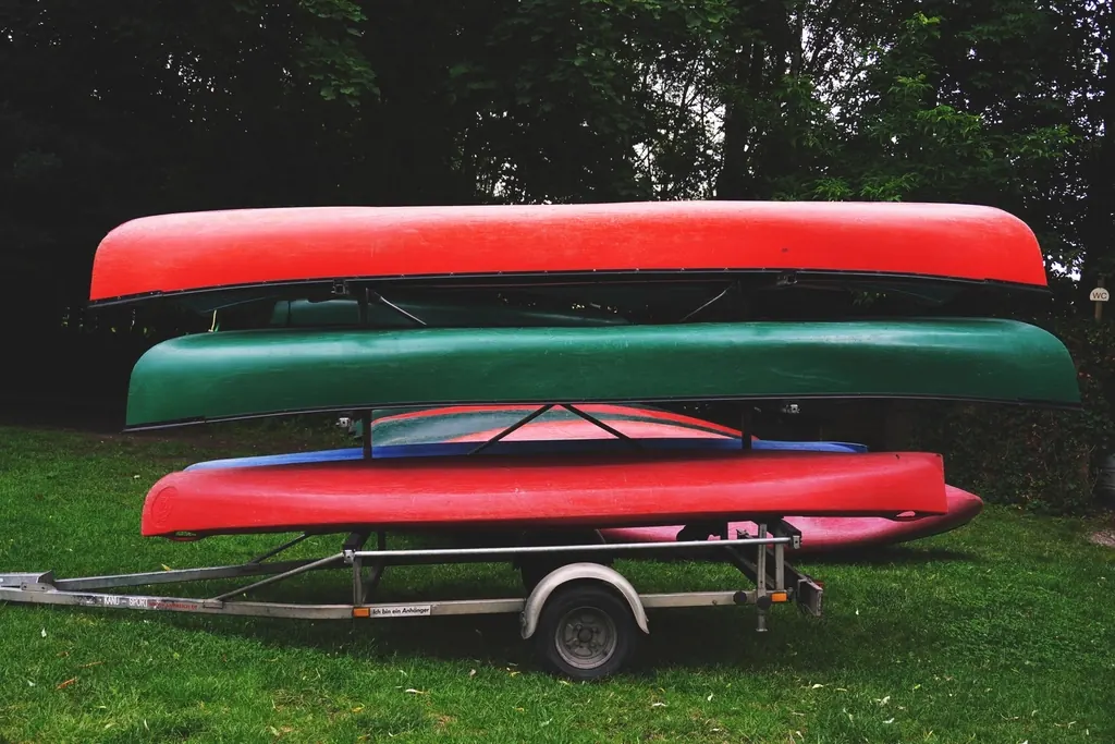 Canoes and kayaks stacked on a trailer